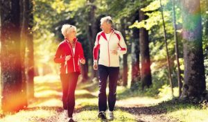 Seniors jogging on a forest road