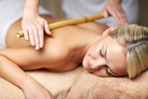 close up of woman lying and having massage in spa